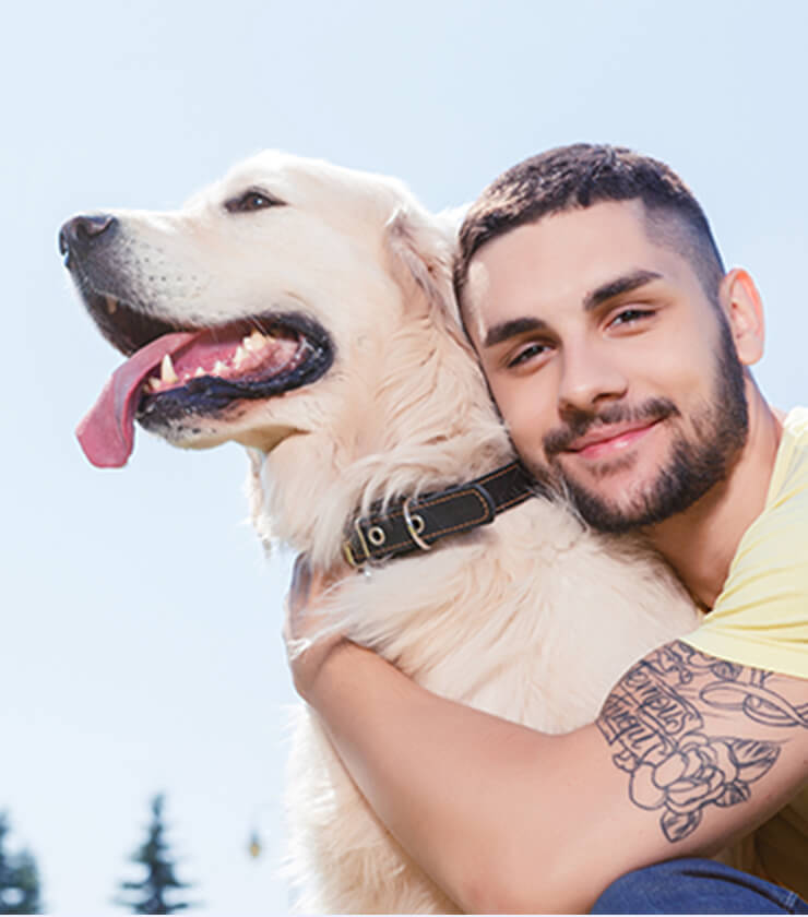 Tattooed guy with happy dog